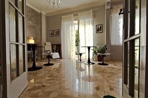 a living room with a marble floor and a piano at Vivi Lucca con "Madame Fannj" - Camera Verde in Lucca