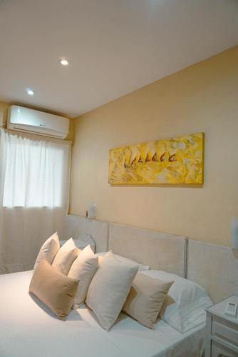 a bedroom with a bed with white pillows at House Park Boutique - Casa de Huéspedes in Santa Fe
