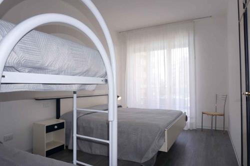 a bedroom with a bunk bed with an archway at Apartment in Porto Santa Margherita 48301 in Porto Santa Margherita di Caorle
