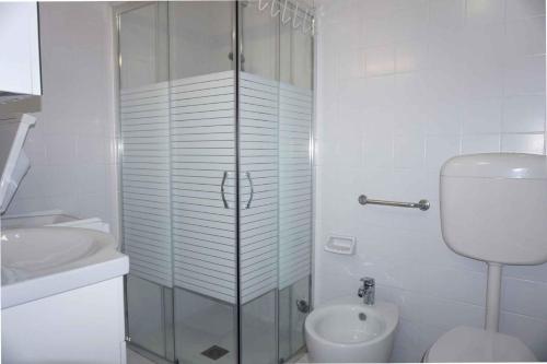 a bathroom with a shower and a toilet and a sink at Apartment in Porto Santa Margherita 48301 in Porto Santa Margherita di Caorle