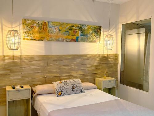 a bedroom with two beds and a wooden headboard at House Park Boutique - Casa de Huéspedes in Santa Fe