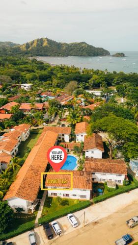 an aerial view of a resort with a sign at Designer-inspired 1bed1bath Condo Close To Beach in Coco