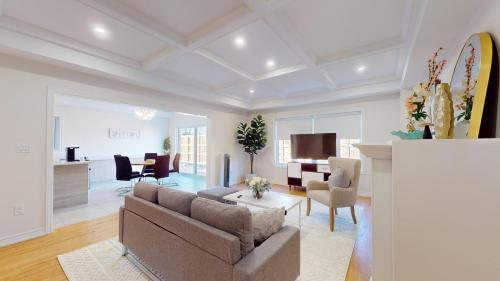 a living room with a couch and a table at New Custom-built House Close to Rogers Stadium in Toronto