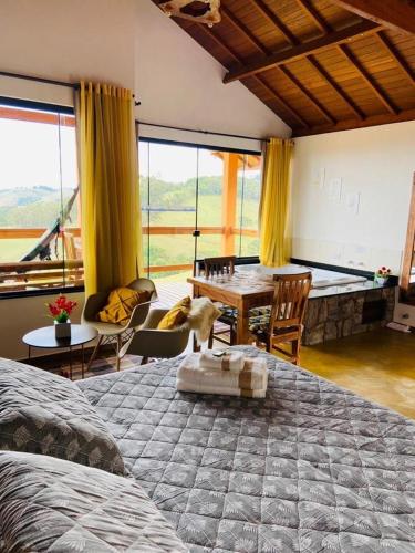 a bedroom with a bed and a table with a dog on it at Chalés Terras Altas in Gonçalves