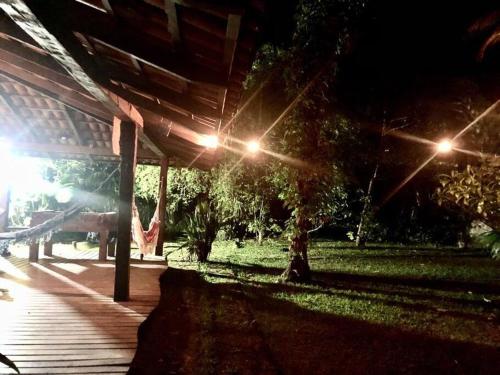a night view of a porch with lights on it at Casa de campo na praia in São Sebastião