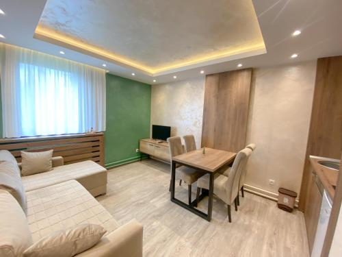 a living room with a table and a couch at MB Apartmani Kopaonik in Kopaonik