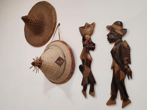a group of figurines and a hat on a wall at Centro Storico - La Dimora del Pellegrino in Capua