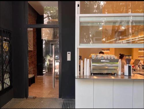 a woman standing at a counter in a restaurant at Departamento a estrenar, Palermo Hollywood VII in Buenos Aires