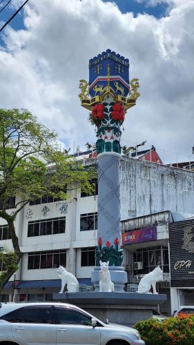a large clock tower in front of a building at Kuching Cozy comfort RDA1608C - Riverine Diamond 4 pax in Kuching