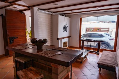 a dining room with a table and a car outside at Casa Macondo Sachica-Villa de Leyva in Sáchica
