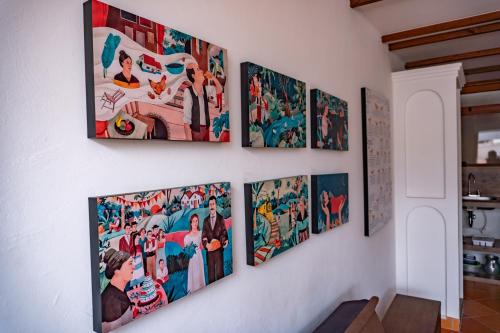 a group of pictures on a wall at Casa Macondo Sachica-Villa de Leyva in Sáchica