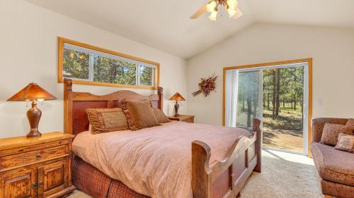 a bedroom with a bed and a chair and a window at Yellow Pine 36 in Sunriver