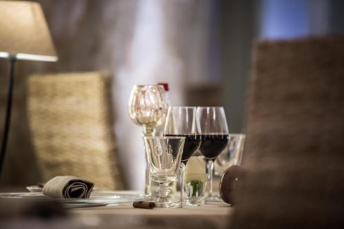 a table with three glasses of wine on it at La Regalido in Fontvieille