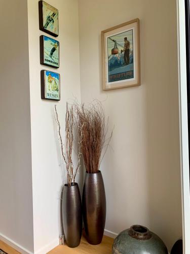 two vases sitting on a table in a room at Alpine Abode in Wanaka