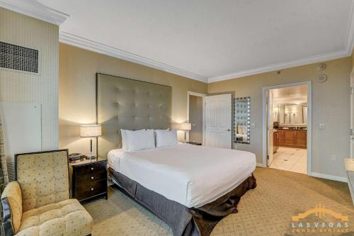a hotel room with a large bed and a chair at MGM Signature-09-820 1Br 2Ba F1 Pits View Balcony in Las Vegas