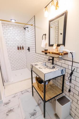 a bathroom with a sink and a shower at Dollhouse Downtown in Fairbanks