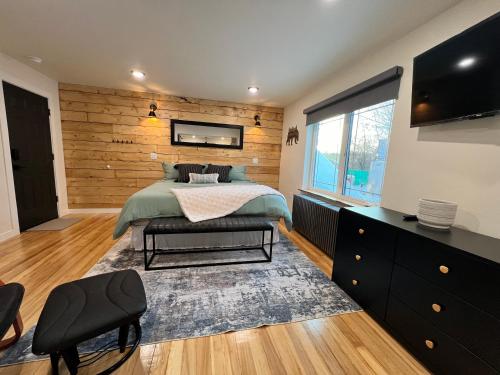 a bedroom with a bed and a large window at Dollhouse Downtown in Fairbanks