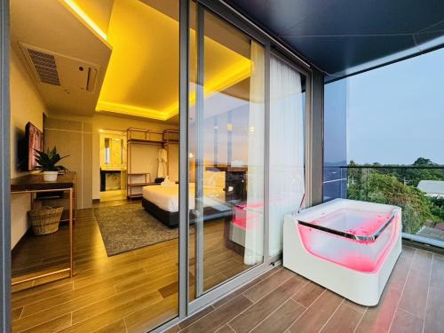 a room with a view of a bedroom at The Blue Mavi Hotel in Chalong 