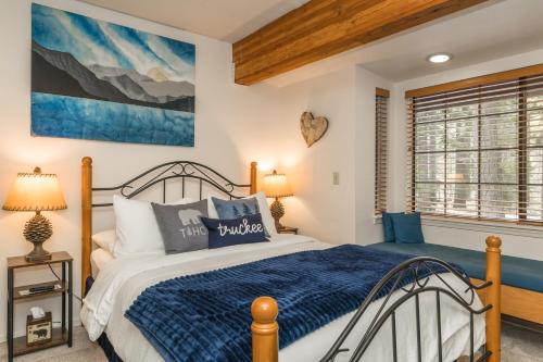 a bedroom with a bed with a blue comforter at Donner Lake Inn in Truckee