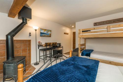 a bedroom with a bunk bed and a wood stove at Donner Lake Inn in Truckee
