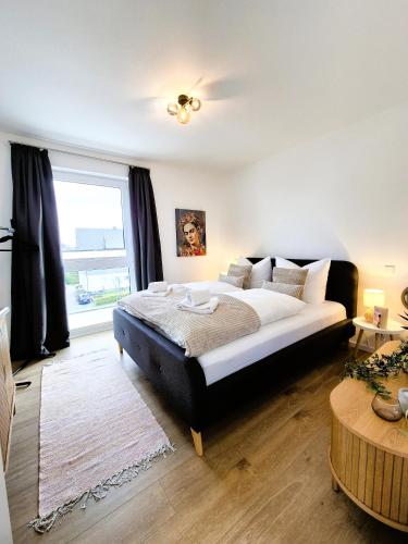 a bedroom with a large bed and a large window at Winterberg Appartement 21132 in Winterberg
