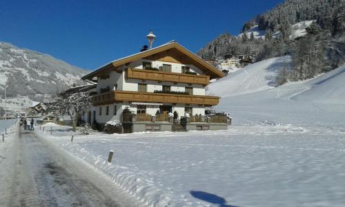 a building in the snow on a snow covered mountain at Jogglerhof in Ramsau im Zillertal