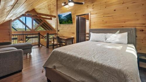 a bedroom with a bed and a desk in a room at The Great Escape - 2 Bedrooms, 2,5 Baths, Sleeps 12 home in Tellico Plains