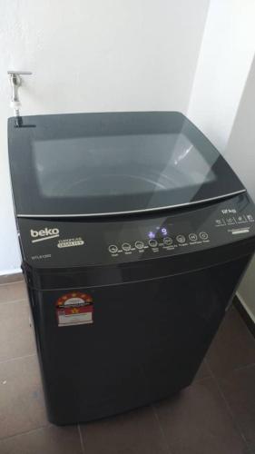 a black appliance sitting on top of a floor at HAPPY STAY MOTEL in Jitra
