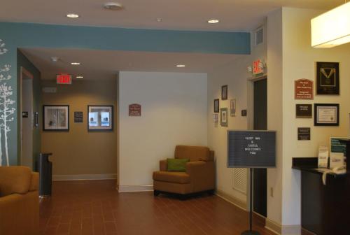 a waiting room with two chairs and a sign at Sleep Inn & Suites Clintwood in Clintwood