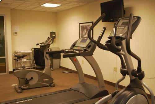 a gym with two tread machines and a phone on a treadmill at Sleep Inn & Suites Clintwood in Clintwood