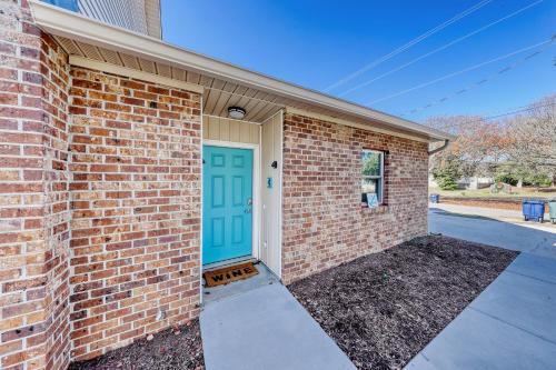 a brick building with a blue door at Tides & Tranquility in Myrtle Beach
