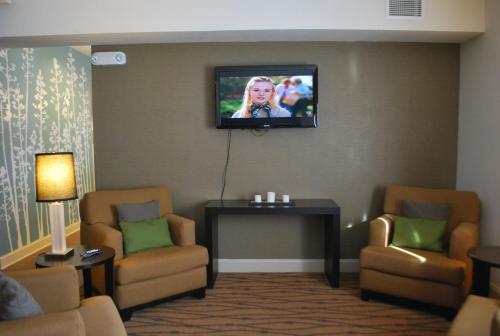 a waiting room with a flat screen tv on the wall at Sleep Inn & Suites Clintwood in Clintwood