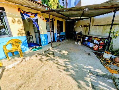 a house with a chair sitting outside of it at Double Room Homestay in Serene Budanilkantha, Northern Kathmandu in Burhānilkantha