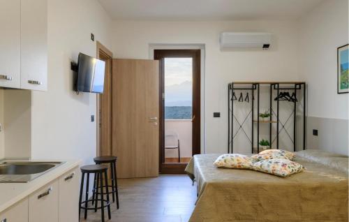a room with a bed and a kitchen with a window at Gorgeous Apartment In Moscufo With Wifi in Moscufo