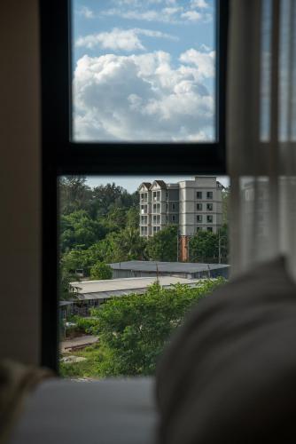 a view of a building from a window at Title Halo Andaman Coast Pool View Gym in Nai Yang Beach