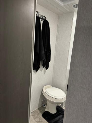a small bathroom with a toilet in a room at Cozy Stationary RV Getaway in Las Vegas