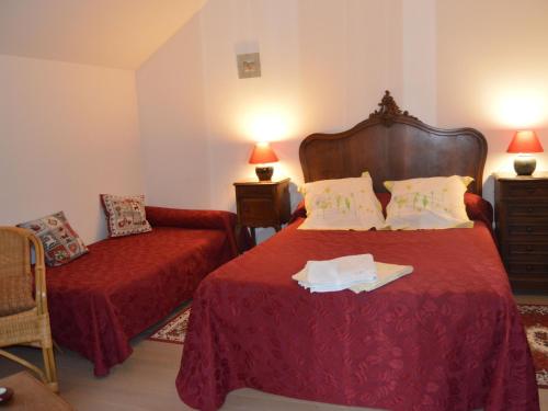 a hotel room with a bed and a chair at Chambres confortables et jardin ombragé dans une ferme du XIXème siècle près de Châteauroux - FR-1-591-699 in Montchevrier