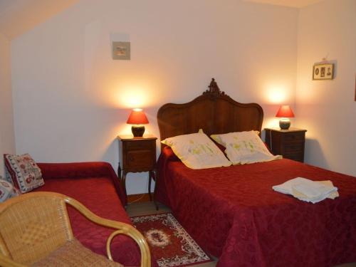a bedroom with two beds and a chair and two lamps at Chambres confortables et jardin ombragé dans une ferme du XIXème siècle près de Châteauroux - FR-1-591-699 in Montchevrier