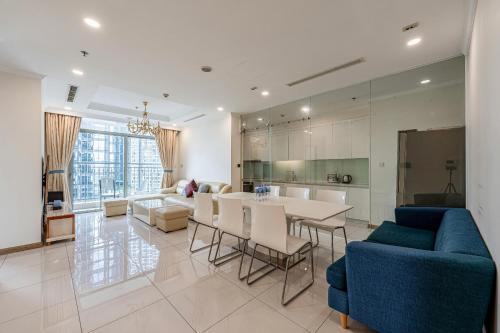 a kitchen and a living room with a table and chairs at Vinhomes Landmark Luxury Apartment by Navie in Ho Chi Minh City