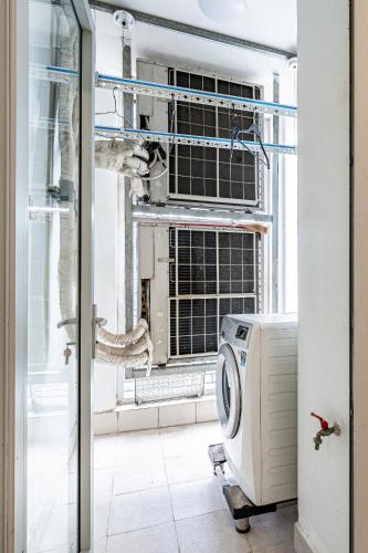 a washing machine in a room with a window at Vinhomes Landmark Luxury Apartment by Navie in Ho Chi Minh City