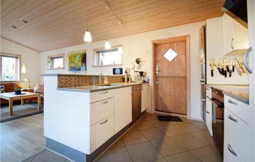 a kitchen with white cabinets and a counter top at 3 Bedroom Pet Friendly Home In Fårvang in Fårvang
