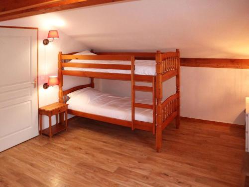 deux lits superposés dans une chambre avec parquet dans l'établissement Appartement duplex 3 pièces 8 pers, piscine et sauna, ski aux pieds, animaux admis - FR-1-322-657, aux Orres