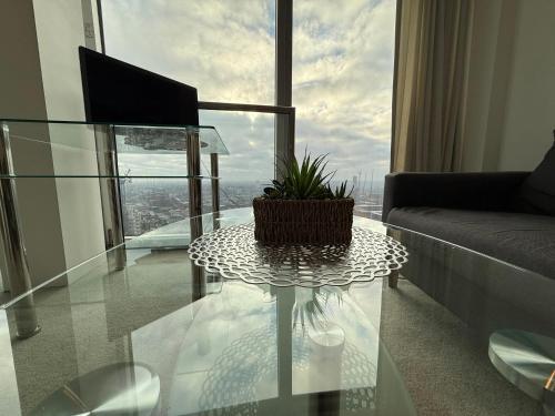 a living room with a glass table with a plant on it at STUNNING!!! City-Center!! Retreat with Modern Amenities in Birmingham