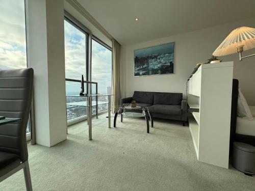 a living room with a couch and a large window at STUNNING!!! City-Center!! Retreat with Modern Amenities in Birmingham