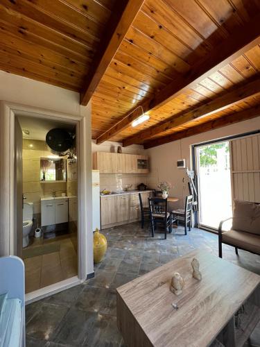 a kitchen and living room with a wooden ceiling at Village Guest House in Corfu