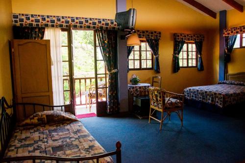 Giường trong phòng chung tại Hotel Viejo Molino Coroico