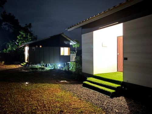 a house with a light on the side of it at Serenehills Retreat in Idukki