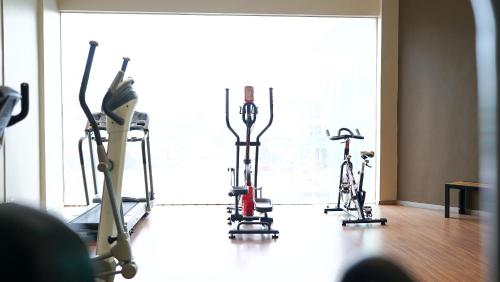 two exercise bikes in a room with a window at The Guest Hotel & Spa in Port Dickson
