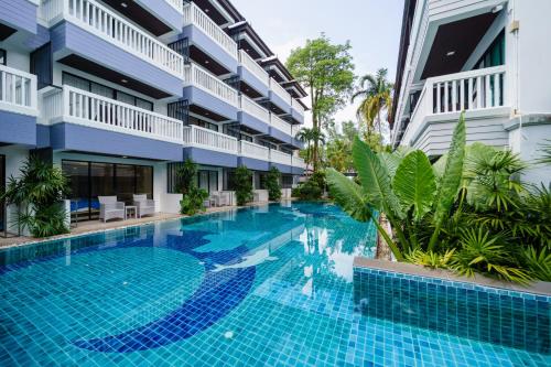 a swimming pool in front of a building at Aonang Buri Resort in Ao Nang Beach