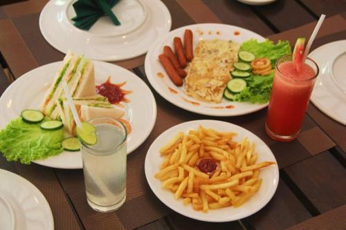a table topped with plates of food and french fries at Seeing Green Udawalawa in Udawalawe